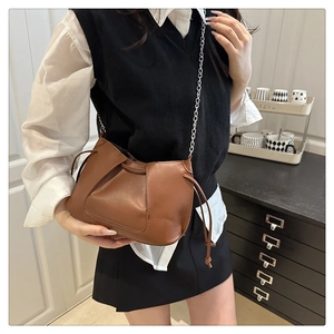 Brown pleated shoulder bag with silver chain strap shown on model for daily styling