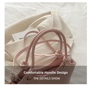 Detail showing the knotted cylindrical handles and embossed pattern on the pink handbag