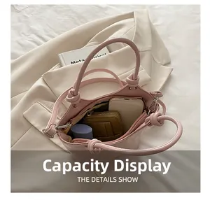 Pink leather bucket bag interior showing large capacity for phone and cosmetics