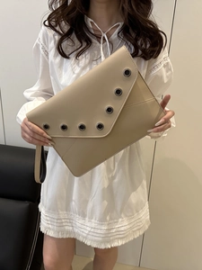 Chic beige envelope clutch bag with silver eyelets and wristlet strap for women