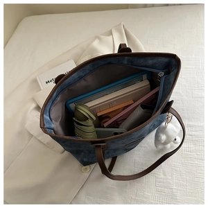 Interior view of large capacity denim tote bag with daily essentials and tablet