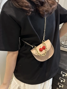 Minimalist beige crossbody bag with 3D cherry charm and chunky gold chain strap