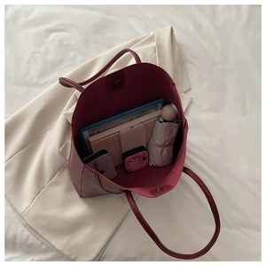 Top view of spacious burgundy leather tote bag showing internal storage for daily essentials