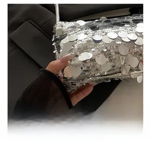 Close-up of silver sequin evening bag showing detailed metallic craftsmanship and texture