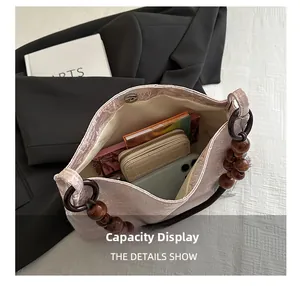 Detail view of pink jacquard bag interior with large capacity and wooden bead handle