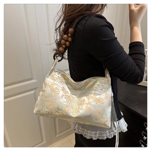 Detail of vintage brocade handbag with mountain landscape print and wooden ring strap