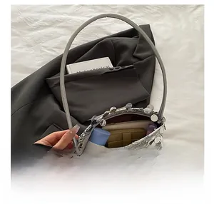 Interior view of silver sequin handbag showing space for phone and wallet essentials