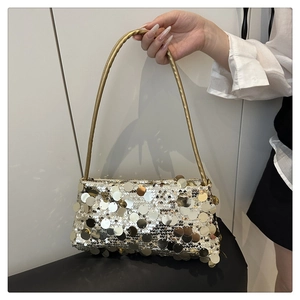 Close-up of sparkling silver and gold sequins on a stylish evening clutch with chain