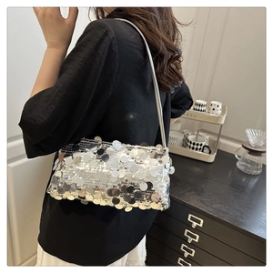 Detailed macro view of shimmering silver sequins on the stylish shoulder bag surface