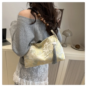 Detail of jacquard fabric shoulder bag with traditional Chinese landscape and wooden beads