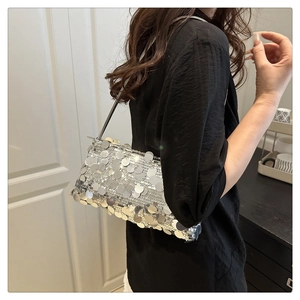 Detail shot of silver sequin shoulder bag with chain strap for party and evening events