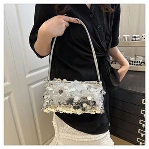 Close-up of silver sequin shoulder bag with large circular metallic paillette details