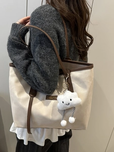 Chic off-white canvas tote bag with brown leather handles and cute cloud pendant