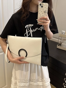 Minimalist white envelope clutch bag with black C-shaped buckle and wristlet strap