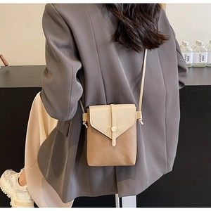 Detailed view of women's two-tone crossbody phone bag with contrast stitching and metal buckle