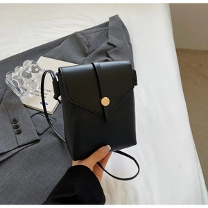 Detail of black pebbled leather mini crossbody phone bag with V-shaped flap and metal buckle