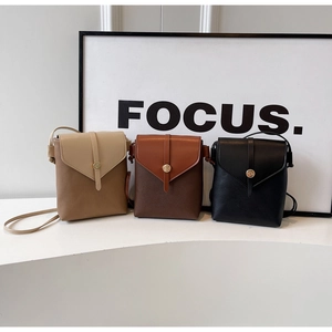 Three minimalist small crossbody phone bags in khaki, brown, and black with pebble texture