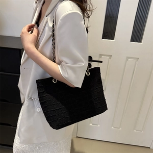 Chic black textured tote bag with gold chain strap for casual and office commute style