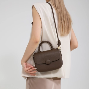 Deep brown lychee textured leather crossbody bag with stylish knot strap and square buckle