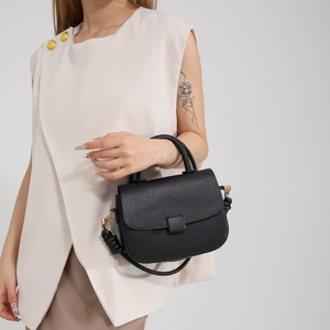 Chic black litchi pattern leather handbag with gold hardware and knotted shoulder strap