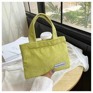 Détail d'un sac cabas en velours côtelé vert clair avec étiquette vintage A GOGO