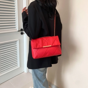 Red quilted leather shoulder bag with gold chain strap and elegant diamond pattern