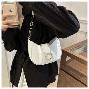 Close-up of white hobo bag with gold chain strap and D-shaped metal buckle detail