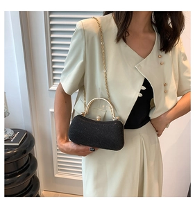 Elegant black glitter evening clutch with gold metal handle and rhinestone clasp detail