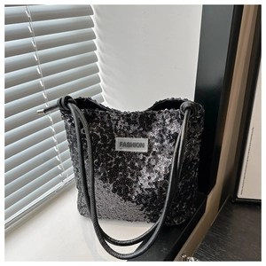 Detail einer schwarzen Pailletten-Tasche mit Hochglanz-Finish und Fashion-Label