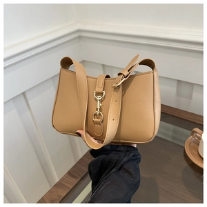 Detailed close-up of khaki leather shoulder bag featuring a gold metal buckle fastener