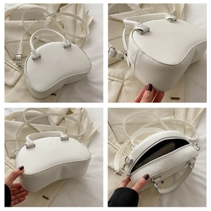 Multi-angle views of white shell crossbody bag with top handles and interior space