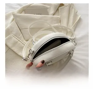 Interior capacity detail of the white PU leather bowling bag with a smartphone inside