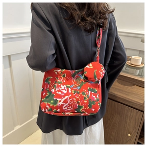 Detail of red floral tote bag with matching round coin purse on a lifestyle background