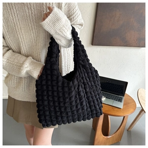 Detail shot of black cloud bubble texture hobo bag with 3D embossed fabric pattern