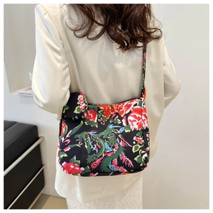 Detail of floral tote bag set featuring red peony and teal dragon print on black fabric