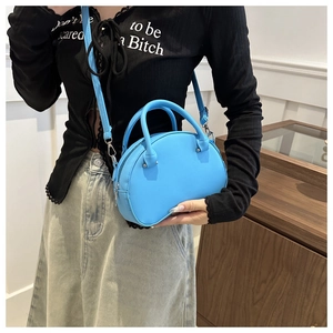 Detail view of sky blue semi-circle mini bag with silver metal hooks and top handles
