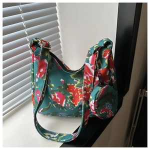 Macro shot of green floral tote bag with waterproof nylon fabric and a round coin purse