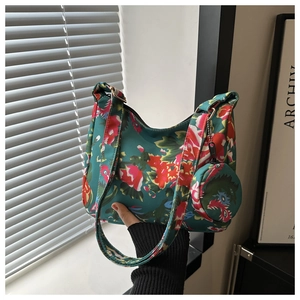 Detail of floral tote bag with matching round coin purse and wide patterned strap