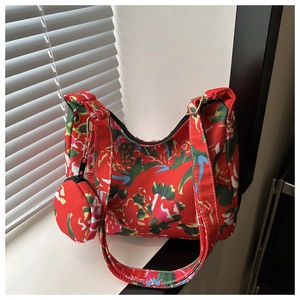 Floral print shoulder bag detail featuring a matching round coin purse and wide strap