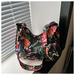 Detail of floral tote bag showing golden buckle, zip closure and small round coin purse