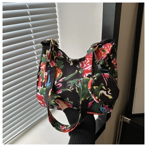 Floral print tote bag detail with matching mini pouch and smooth zipper closure