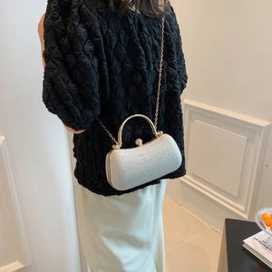 Elegant silver glitter clutch with gold curved handle and chain strap for women