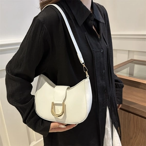 White faux leather crescent shoulder bag with gold hardware buckle and crossbody strap