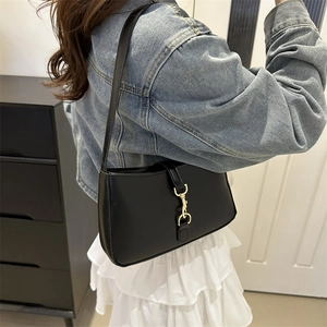 Minimalist black leather underarm shoulder bag with golden metallic hook clasp buckle