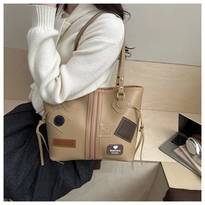 Chic beige PU leather tote bag shown in a lifestyle office setting with laptop