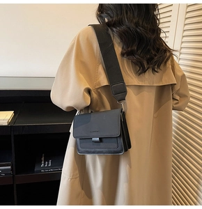 Detail view of black matte square crossbody bag with Fashion & Bags embossed logo