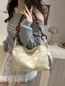 Exquisite brocade handbag with traditional golden landscape patterns and wooden bead handles
