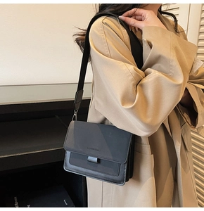 Detail of black matte flap bag with wide strap and Fashion & Bags text on model