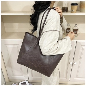 Detail view of large dark brown retro PU leather tote bag with long double straps