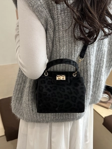 Minimalist black leopard print handbag with gold hardware and shoulder strap for women